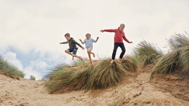 kids playing on sand dunes